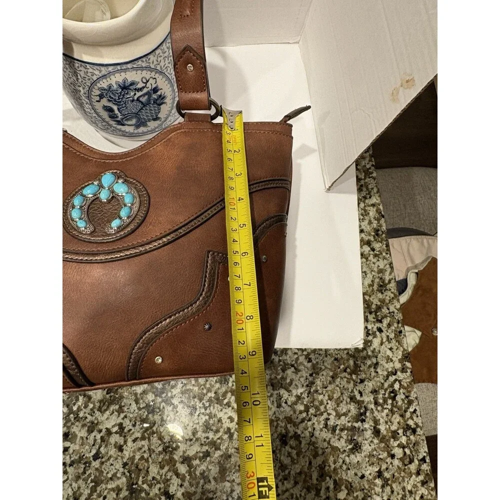 brown faux-leather Justin Naja Concho bag accented with a turquoise